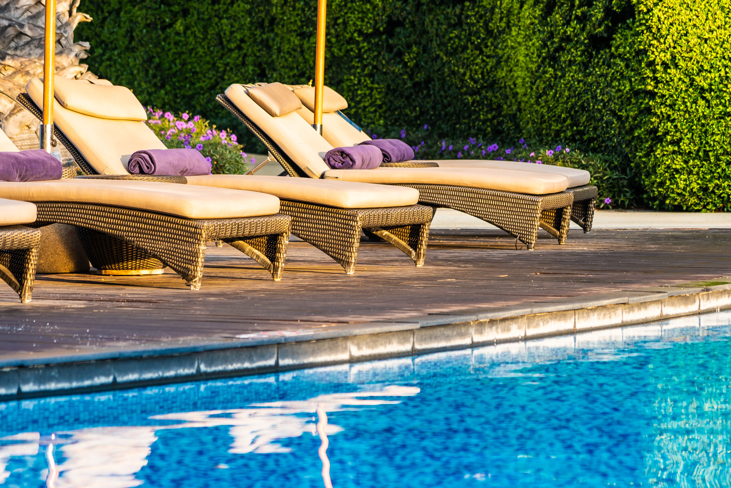 Beautiful outdoor swimming pool with bed deck chair and umbrella Beautiful outdoor swimming pool with bed deck chair and umbrella in resort for travel and vacation concept